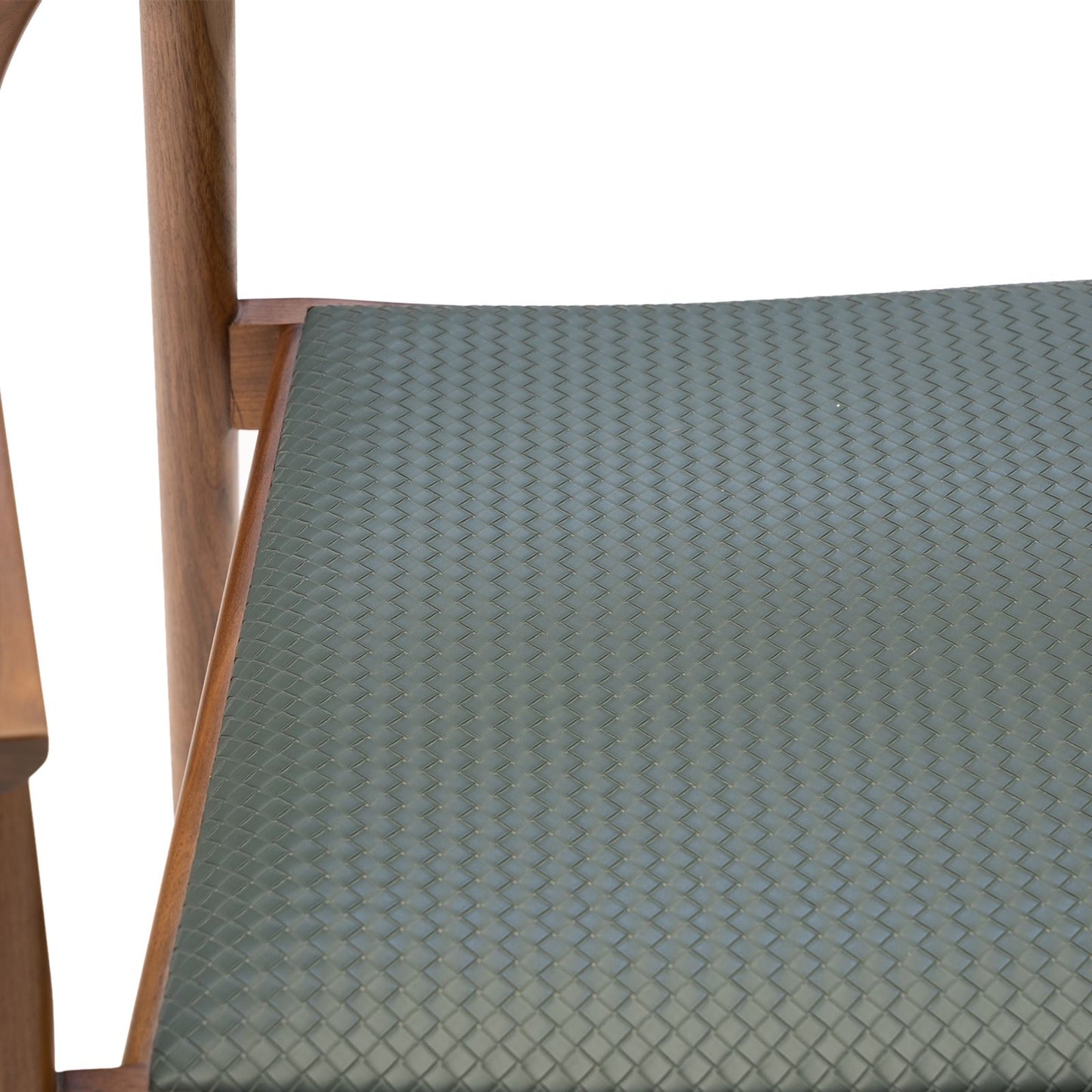 Close-up of woven green seat cushion on a wooden chair frame with a white background