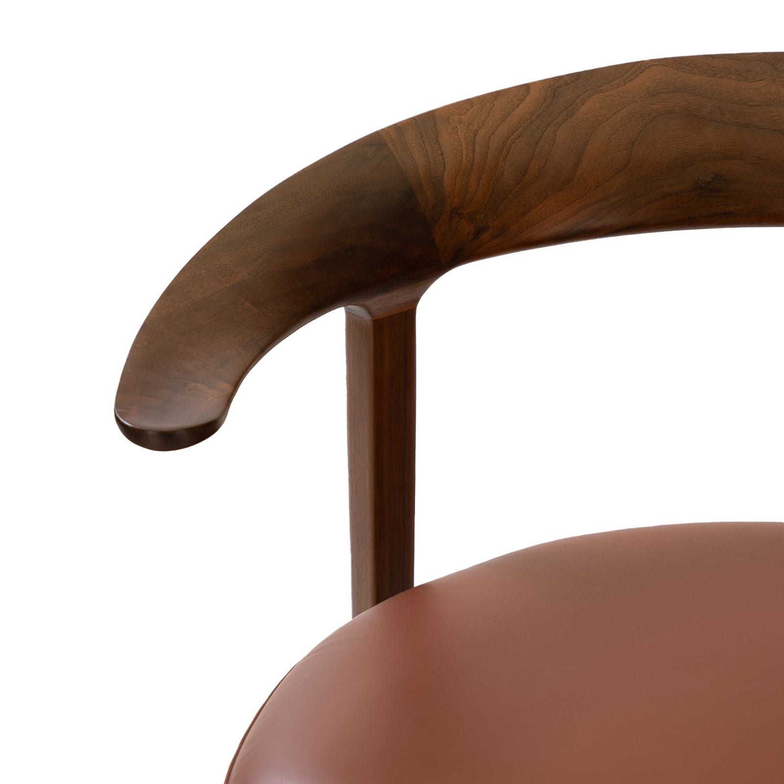 Close-up of a modern chair with curved dark wood armrest and smooth brown leather seat