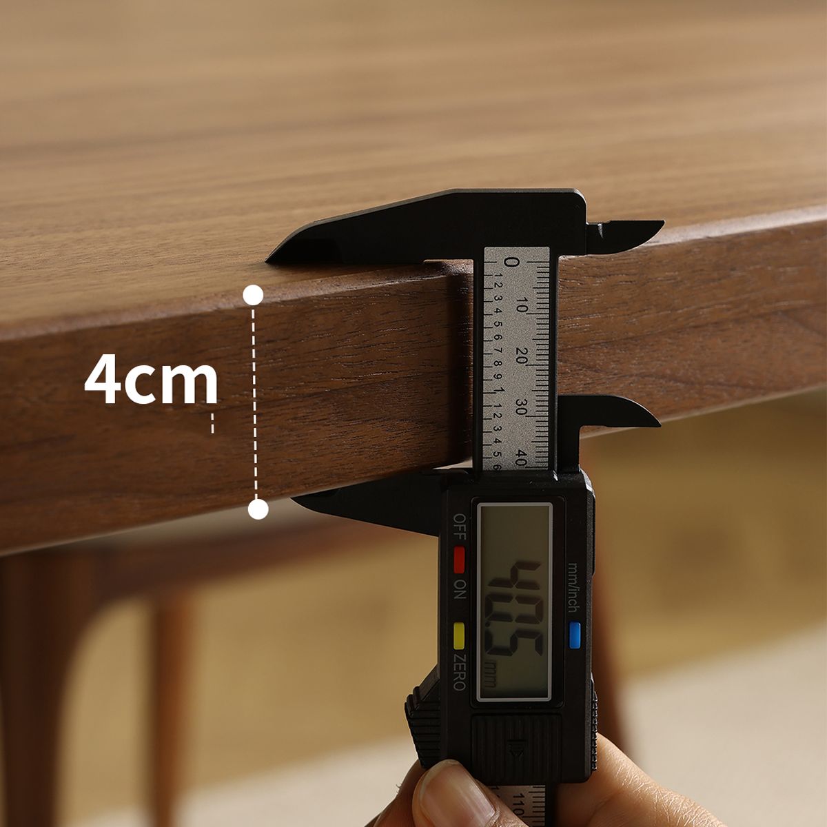 Digital caliper measuring wooden furniture thickness at 4.05 cm, close-up of wood grain surface