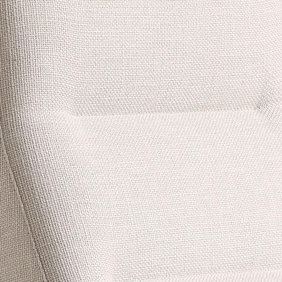 Close-up of textured light beige fabric upholstery on a modern chair cushion
