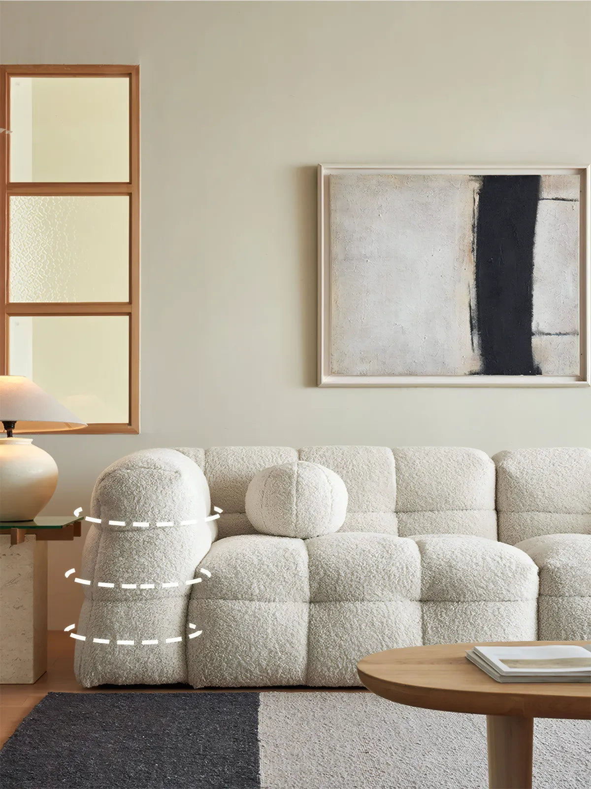 Side profile of Cumberland sofa showing the curved organic armrest design and deep seat structure with solid walnut internal frame.