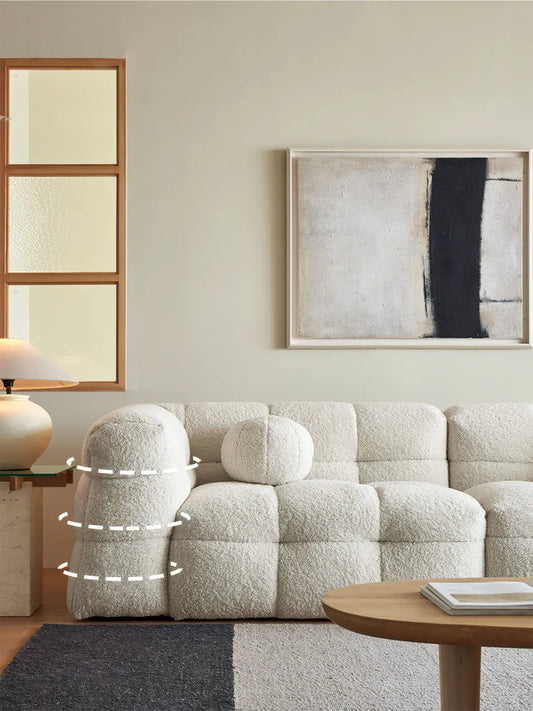 Side profile of Cumberland sofa showing the curved organic armrest design and deep seat structure with solid walnut internal frame.