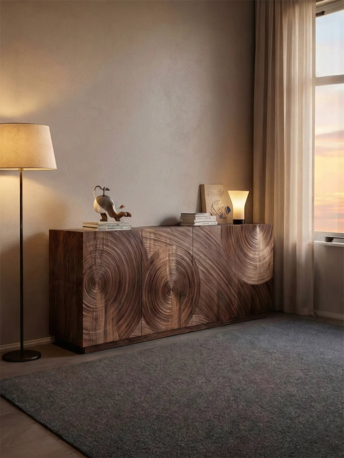 The Curator media console styled in a warm, modern living room setting next to a floor lamp and large window.