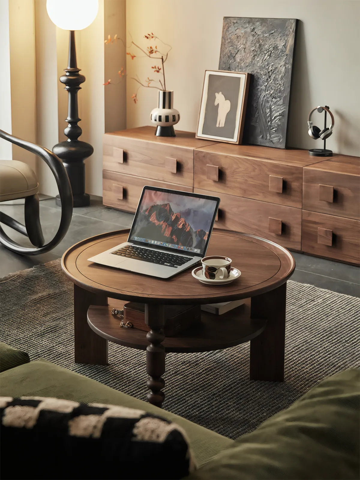 Elegant living room setup featuring a solid black walnut coffee table paired with a modern lounge chair and rug.