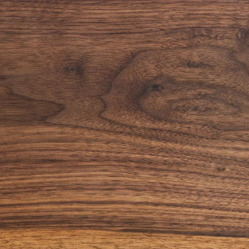 Macro view of fresh-milled American black walnut heartwood showing deep espresso color and open ribbon grain	