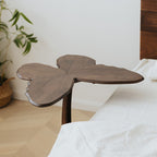 Close-up detail of the hand-carved edges on the solid walnut butterfly end table.
