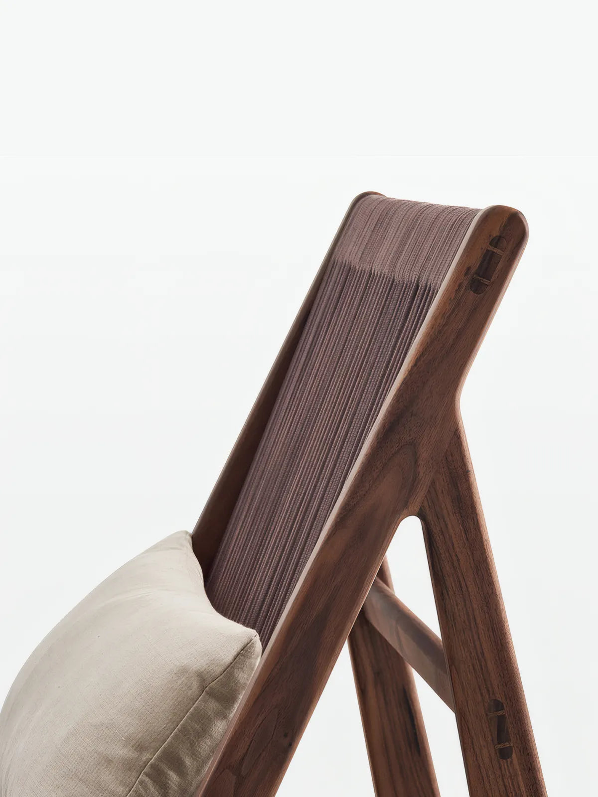 Close-up detail of hand-woven rope texture and solid walnut side frame joinery.