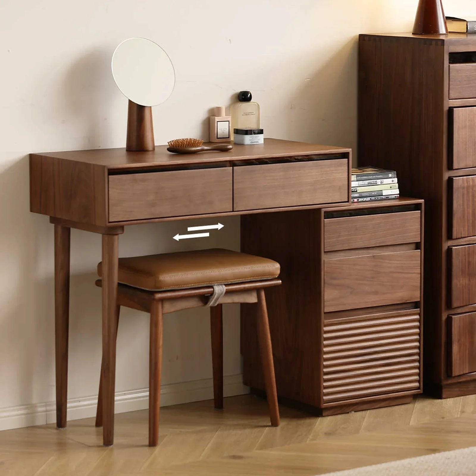 Detail of the overlapping design between the walnut makeup table and bedside storage cabinet.