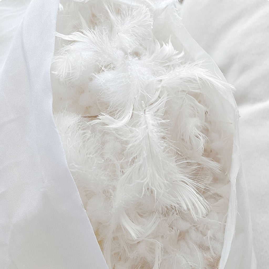 Close-up of white soft feathers inside a pillow showcasing fluffy texture and softness