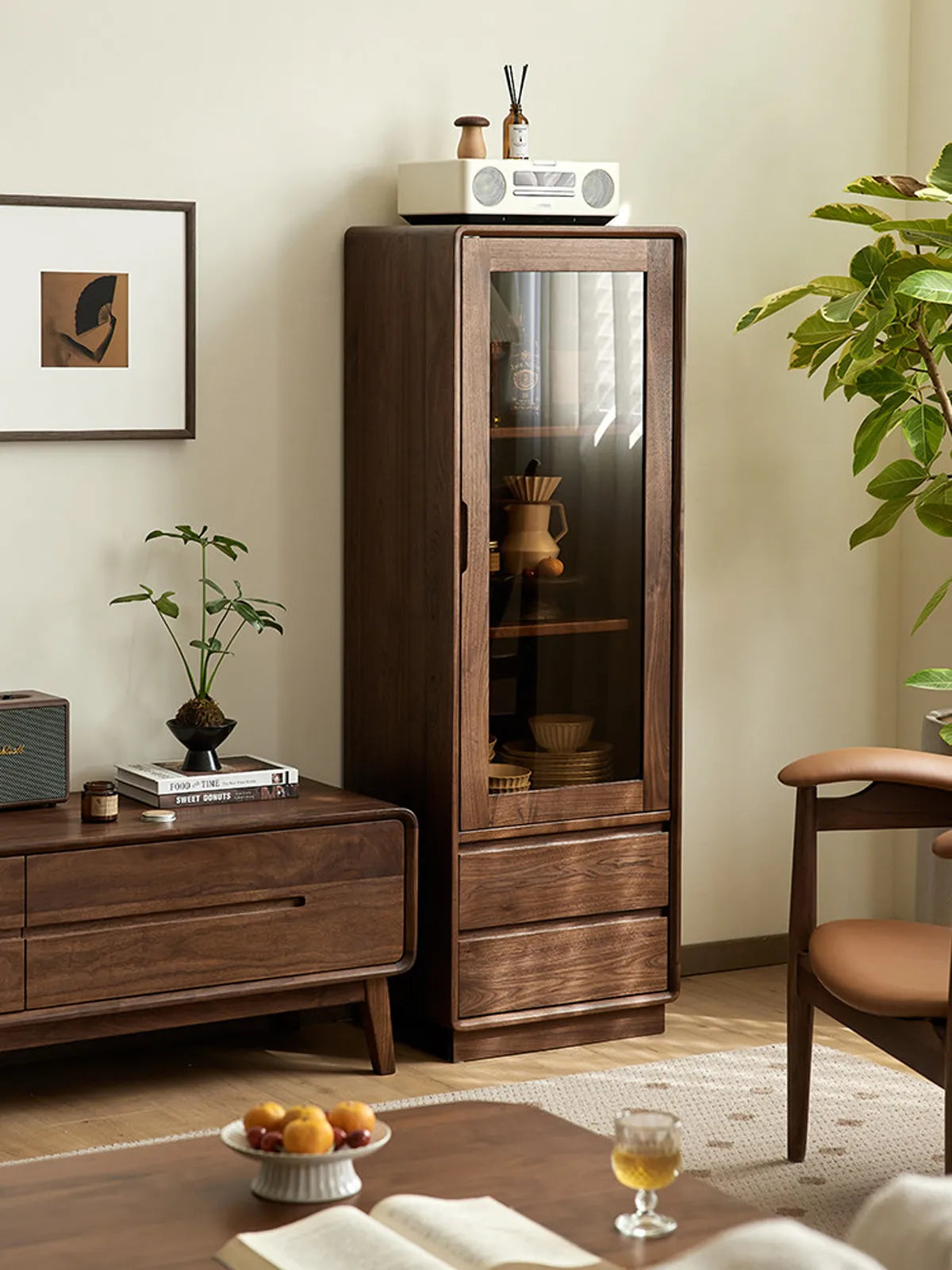 Modern Japandi living room featuring the Kurumi tall narrow display cabinet styled with plants and ceramics.