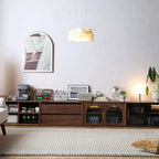 Four walnut modules arranged horizontally to create a long, modern low-profile TV stand.