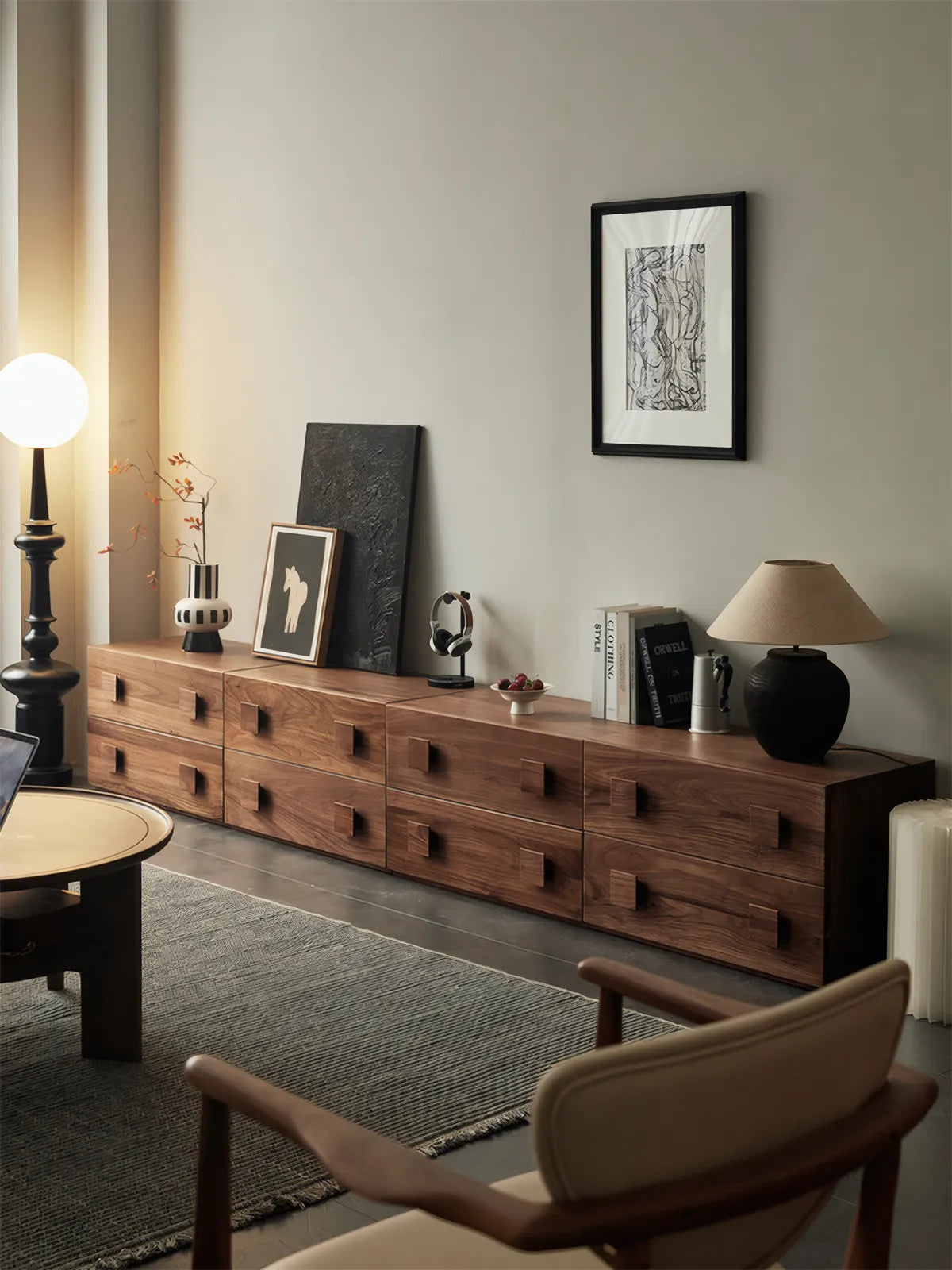 four Walnutry modular units arranged horizontally to create a long, sophisticated solid walnut media console in a living room.
