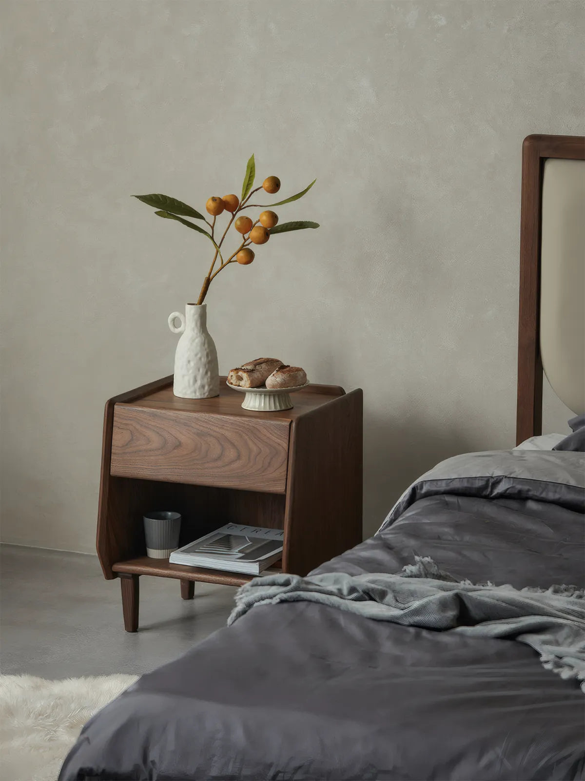 Walnutry nightstand styled next to a bed, illustrating its 20.5-inch height perfect for platform beds.