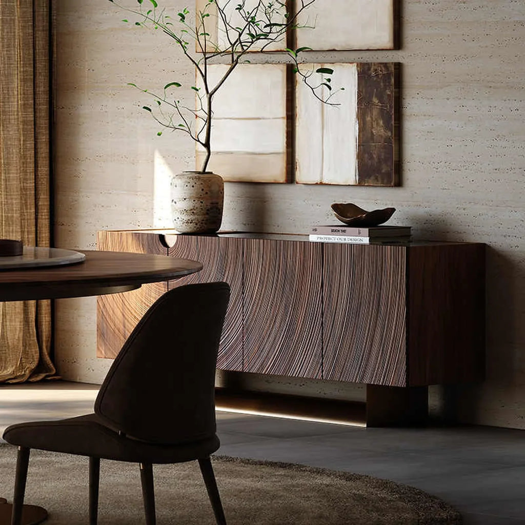 Modern dining room with textured wooden buffet cabinet, round table, dark chair, and minimalist decor