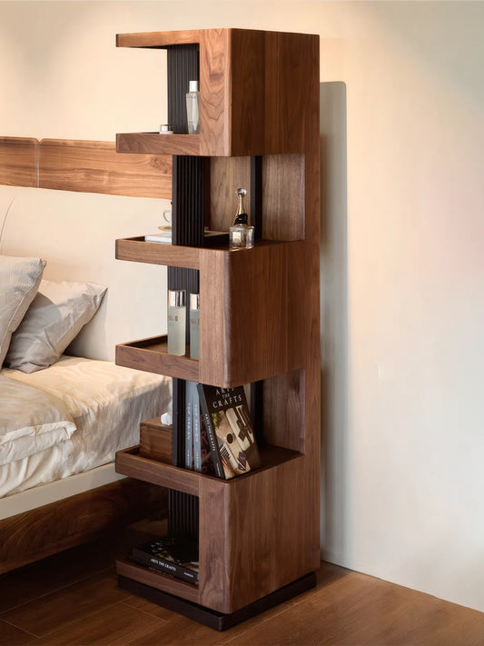 Side profile of the Suiseki rotating tower placed in a bedroom corner, displaying perfumes and books.