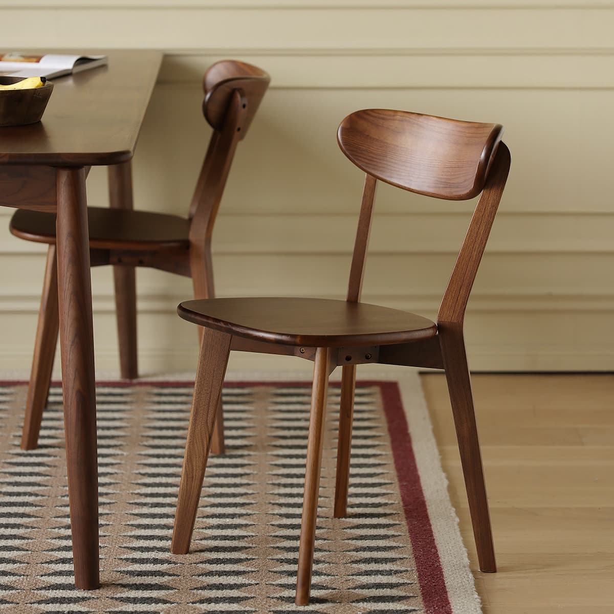 Side profile of the Sylva chair displaying the angled back legs and ergonomic steam-bent backrest support.