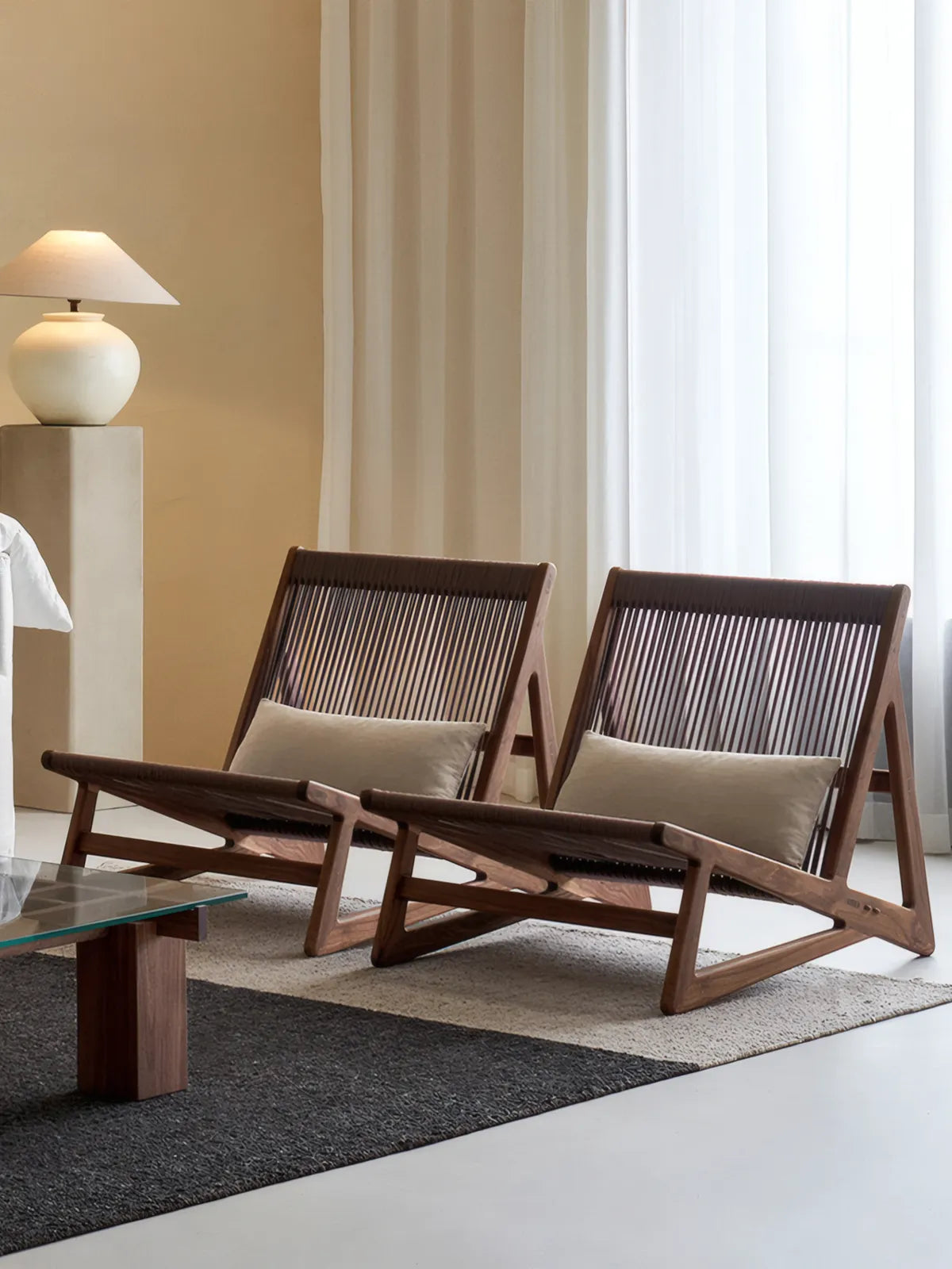 Minimalist Japandi living room layout featuring a pair of Walnutry Suiseki lounge chairs facing a low table.