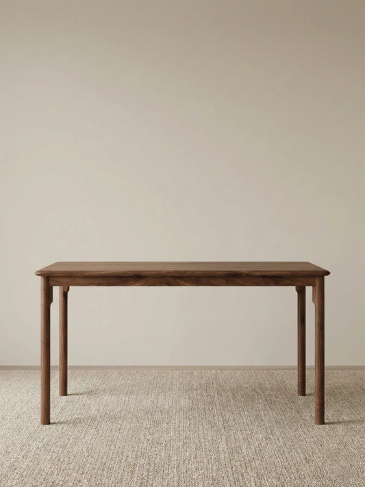 Front view of The Cumberland 63-inch dining table against a plain background, emphasizing the clean lines, tapered legs, and solid wood construction.