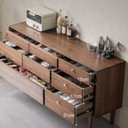 Modern walnut dresser with open drawers showing organized storage and kitchen accessories on top