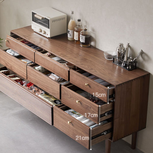 Modern walnut dresser with open drawers showing organized storage and kitchen accessories on top