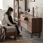 Walnutry Grid 8-drawer solid black walnut dresser with a person in a bedroom