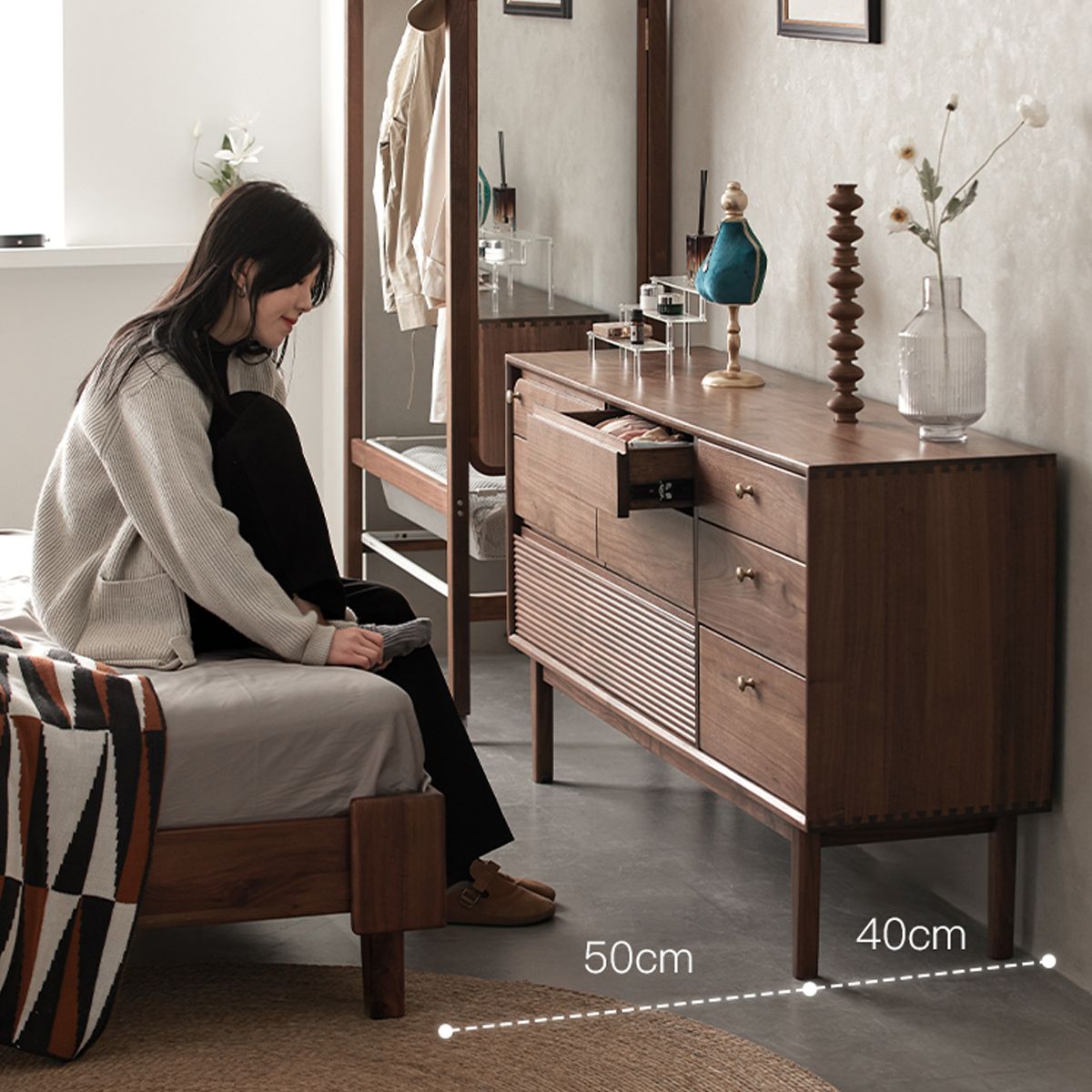 Walnutry Grid 8-drawer solid black walnut dresser with a person in a bedroom