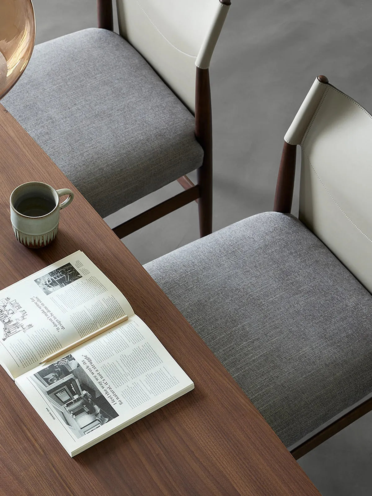 A beautifully styled modern dining room featuring a set of Walnutry Opus chairs paired with a solid wood table and warm lighting.