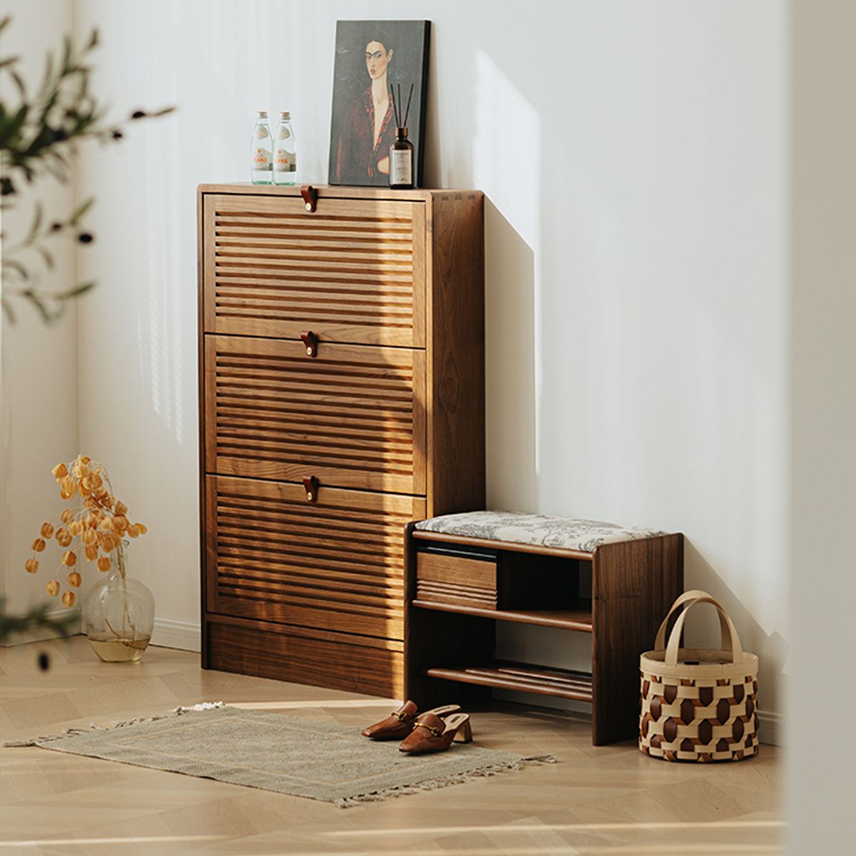 Solid walnut shoe cabinet and bench with patterned cushion in bright modern entryway