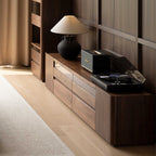 Modern living room walnut entertainment center with record player, speaker, and ceramic lamp