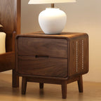 Modern minimalist walnut bedside table with two drawers and a white ceramic lamp on top