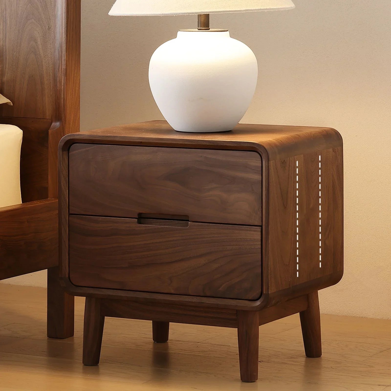 modern minimalist bedside table in solid North American black walnut with two drawers and a white ceramic lamp on top