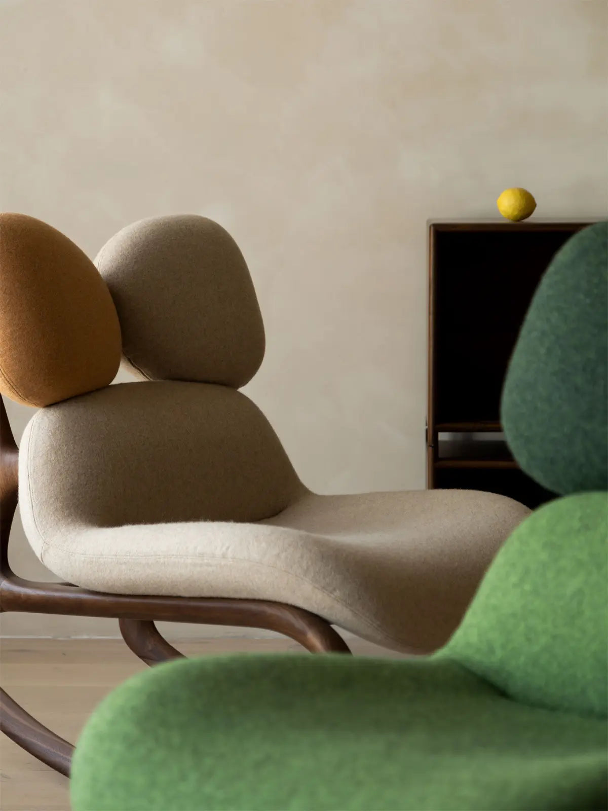 A collection of Cairn Rockers in various upholstery colors including green, earth tones, and beige.