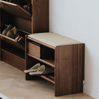 Side profile view of the compact walnut shoe bench designed for narrow hallways and small apartments with microfiber leather.