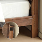 Close-up of natural walnut wood grain bed frame with detailed joinery and white mattress