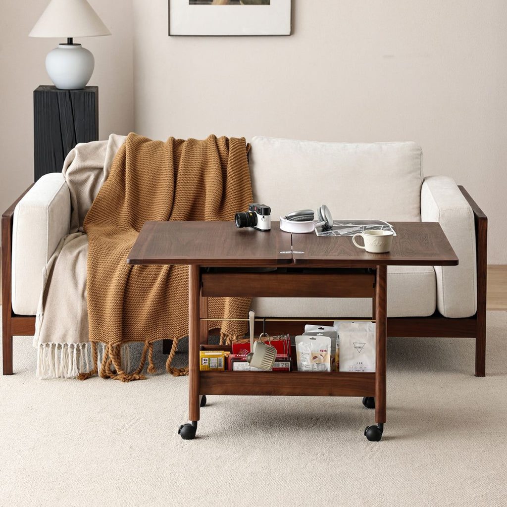 Wooden storage cart with open shelves in front of beige sofa with cozy brown throw in modern living room