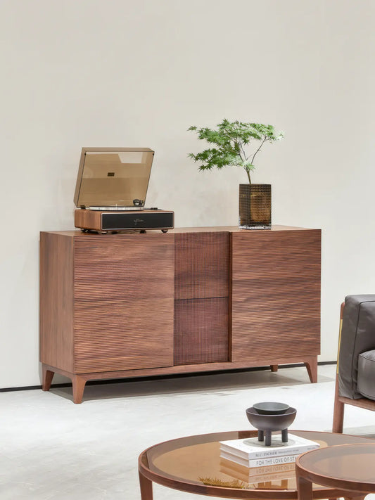 Angled view of The Opus record player stand, highlighting the rich grain of North American black walnut and the tapered leg design.
