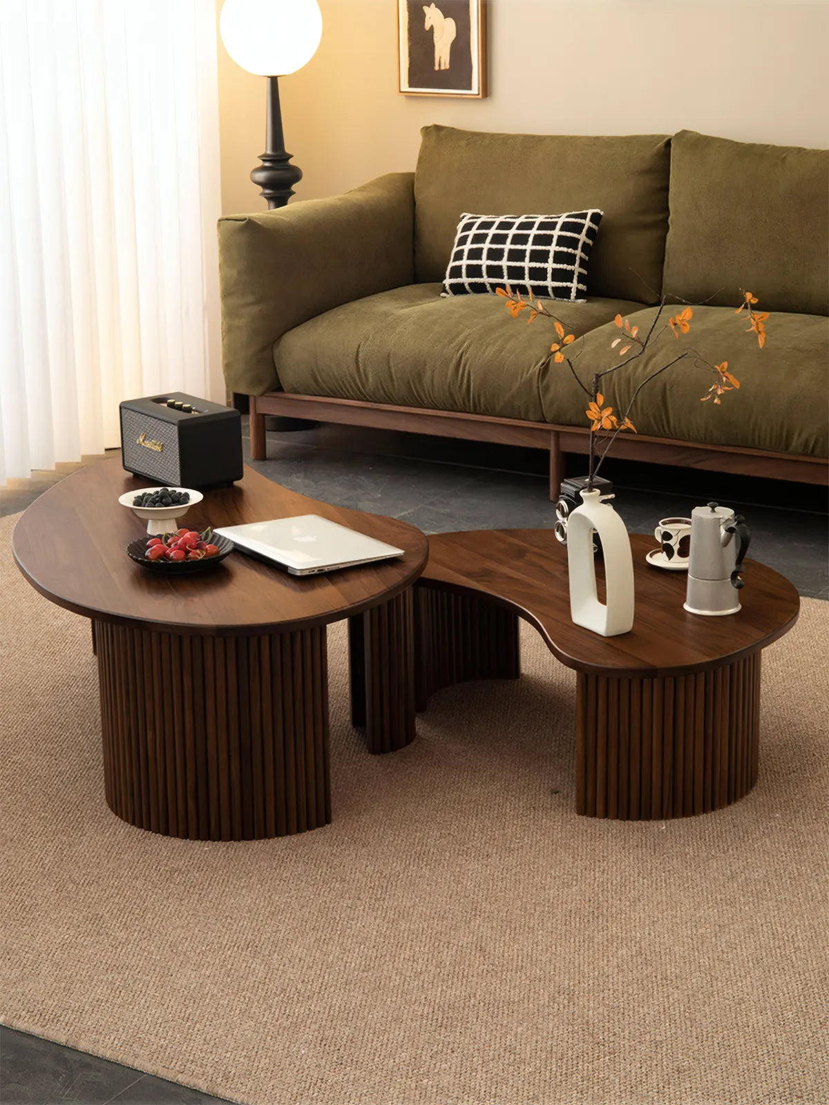 "Top angle view of irregular cloud shaped walnut tables nesting together, displaying natural wood grain."