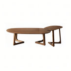 Set of two Walnutry Pebble solid walnut nesting coffee tables with organic irregular shapes.