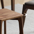 Close-up of the OSMO wood wax oil finish on the solid walnut stool seat.