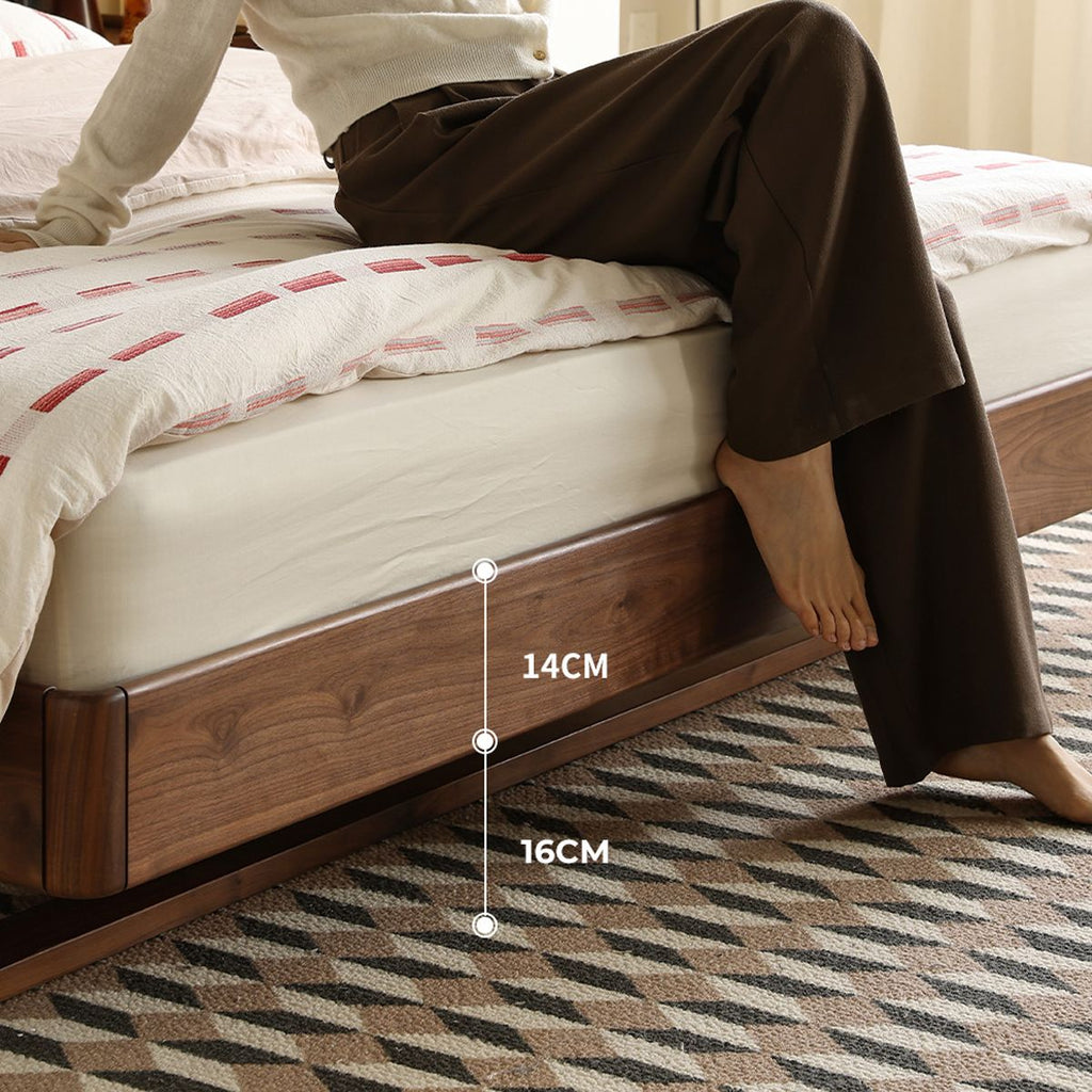 Walnut floating bed base with recessed legs and mattress, modern bedroom setting