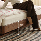 Walnut floating bed base with recessed legs and mattress, modern bedroom setting