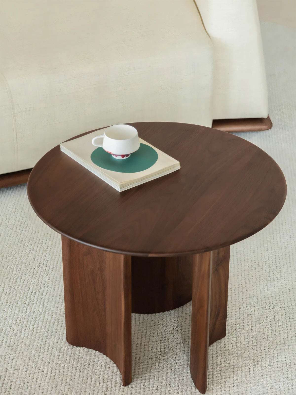 Top view of round walnut end table styled with books and coffee, highlighting the spacious 23.6 inch surface.
