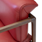Detail showing the smooth, rounded solid walnut wood frame construction of the modern chair.