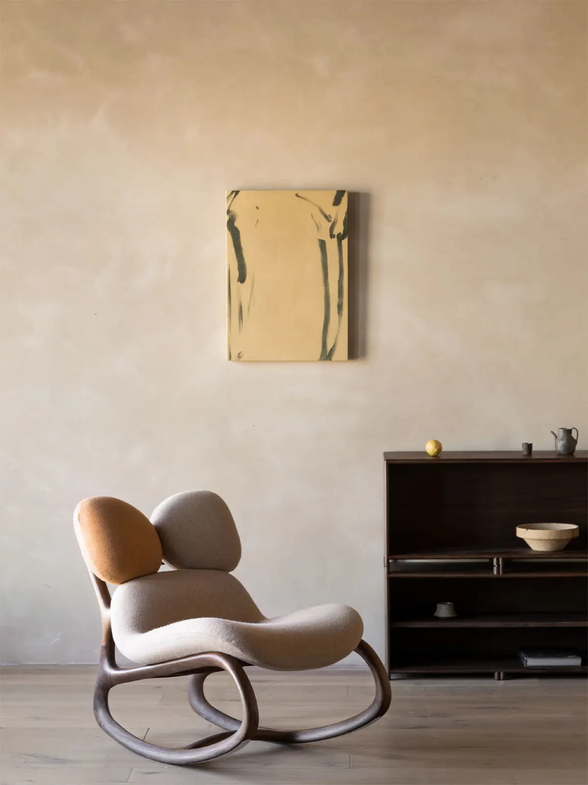 The Cairn Rocker in Autumn Earth colorway, highlighting the sculptural double-pebble backrest design.