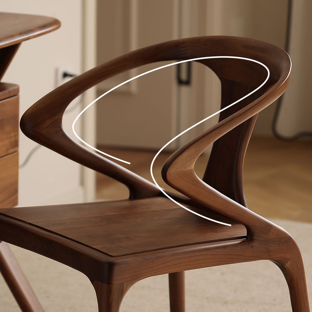 Side profile of the Danish modern walnut chair showing the continuous fluid line of the armrest.