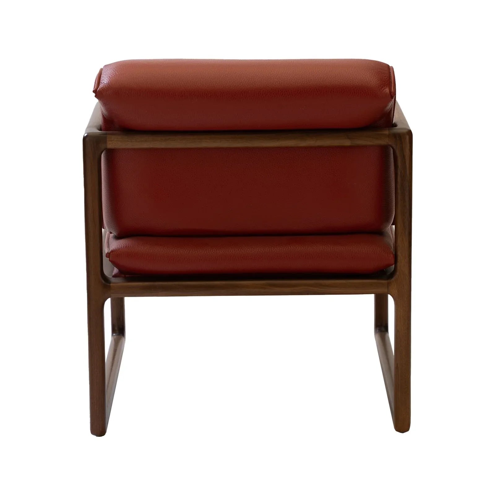 Back profile of modern chair with red leather cushions and walnut wood sled base frame