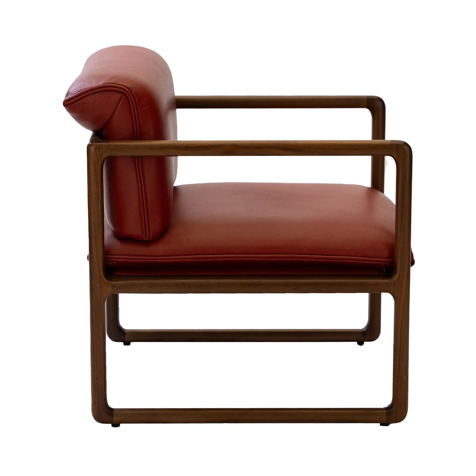 Modern sled base chair with brown leather cushions and wooden frame in side profile