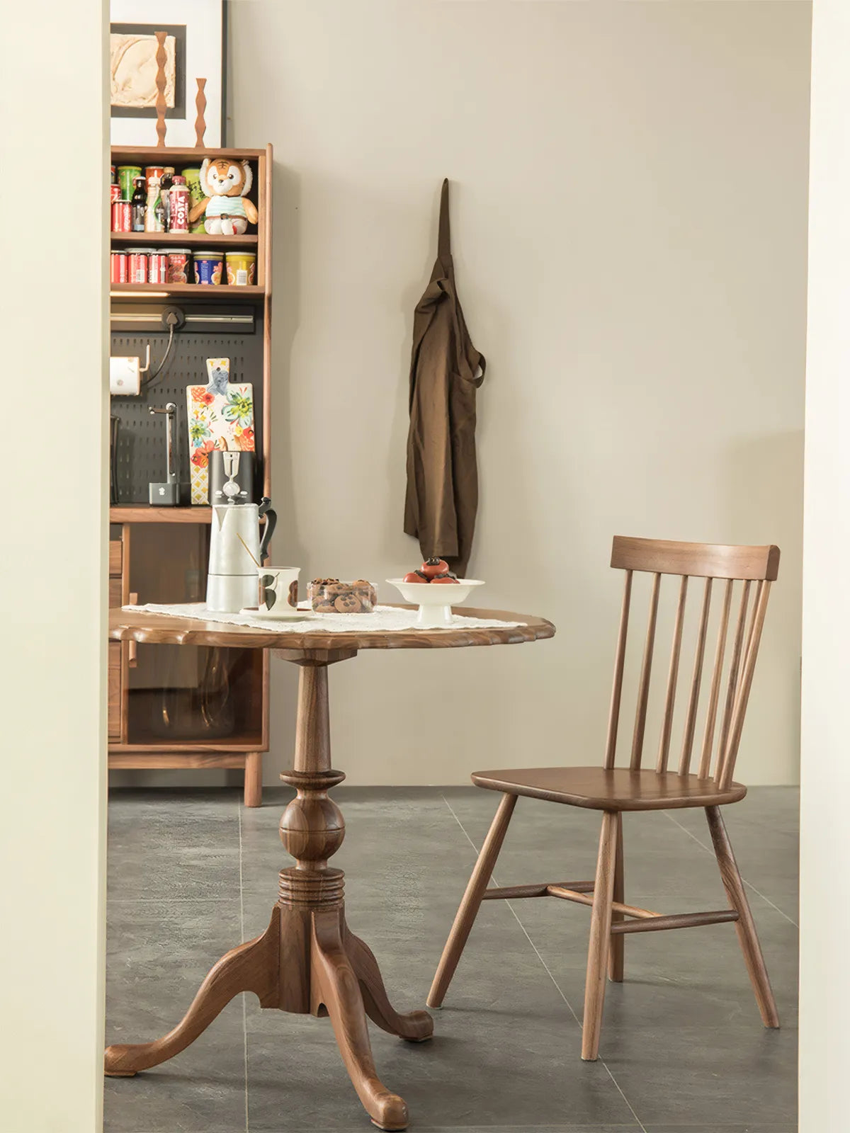 The Margaux 36 inch round table styled in a small apartment corner with a Windsor chair and apron.