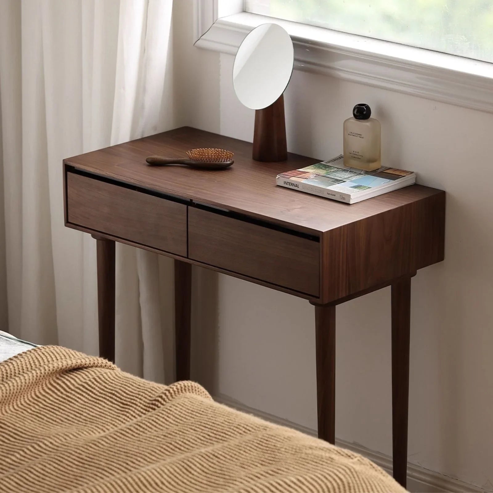 Modern minimalist bedroom featuring a compact solid wood dressing table that doubles as a nightstand.