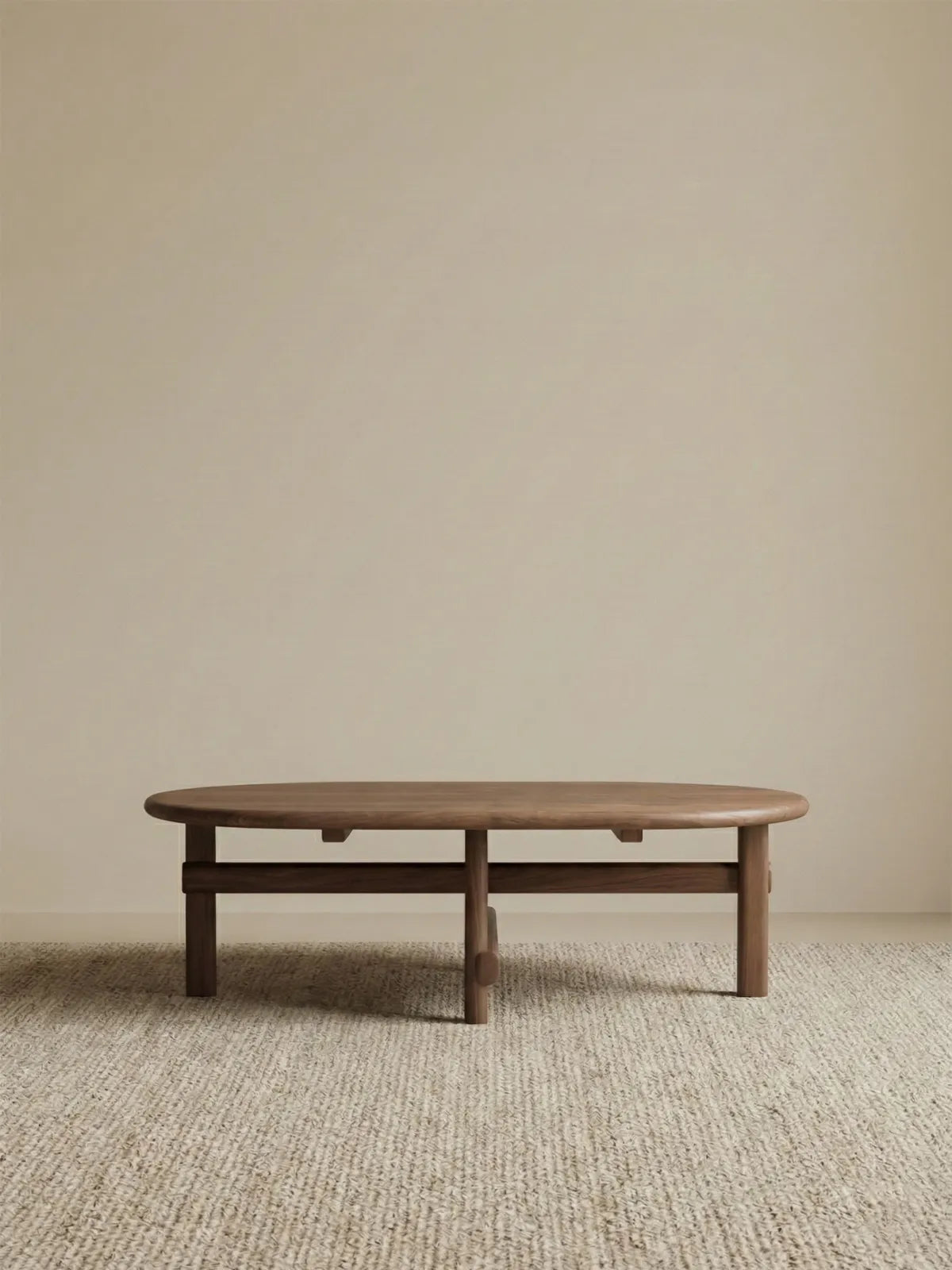 Studio isolation shot of The Suiseki Pebble Table, showcasing the premium joinery and rich grain of the North American Black Walnut timber.